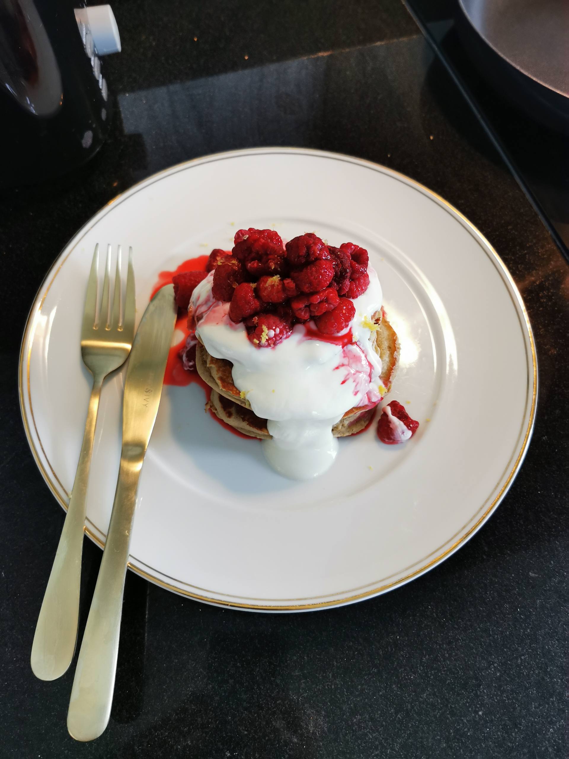 Raspberry Pancakes on a plate with greek yogurt