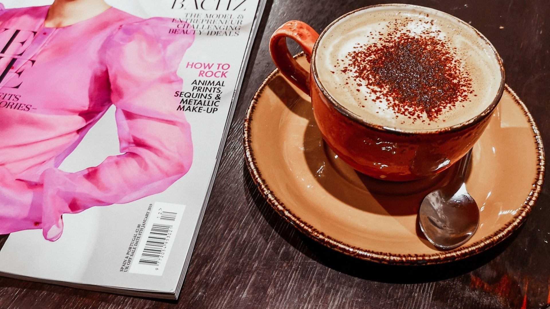 Cappuccino and a Magazine in a coffee shop
