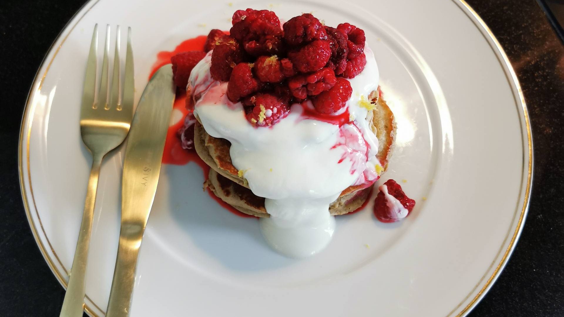 Raspberry Pancakes on a plate with greek yogurt